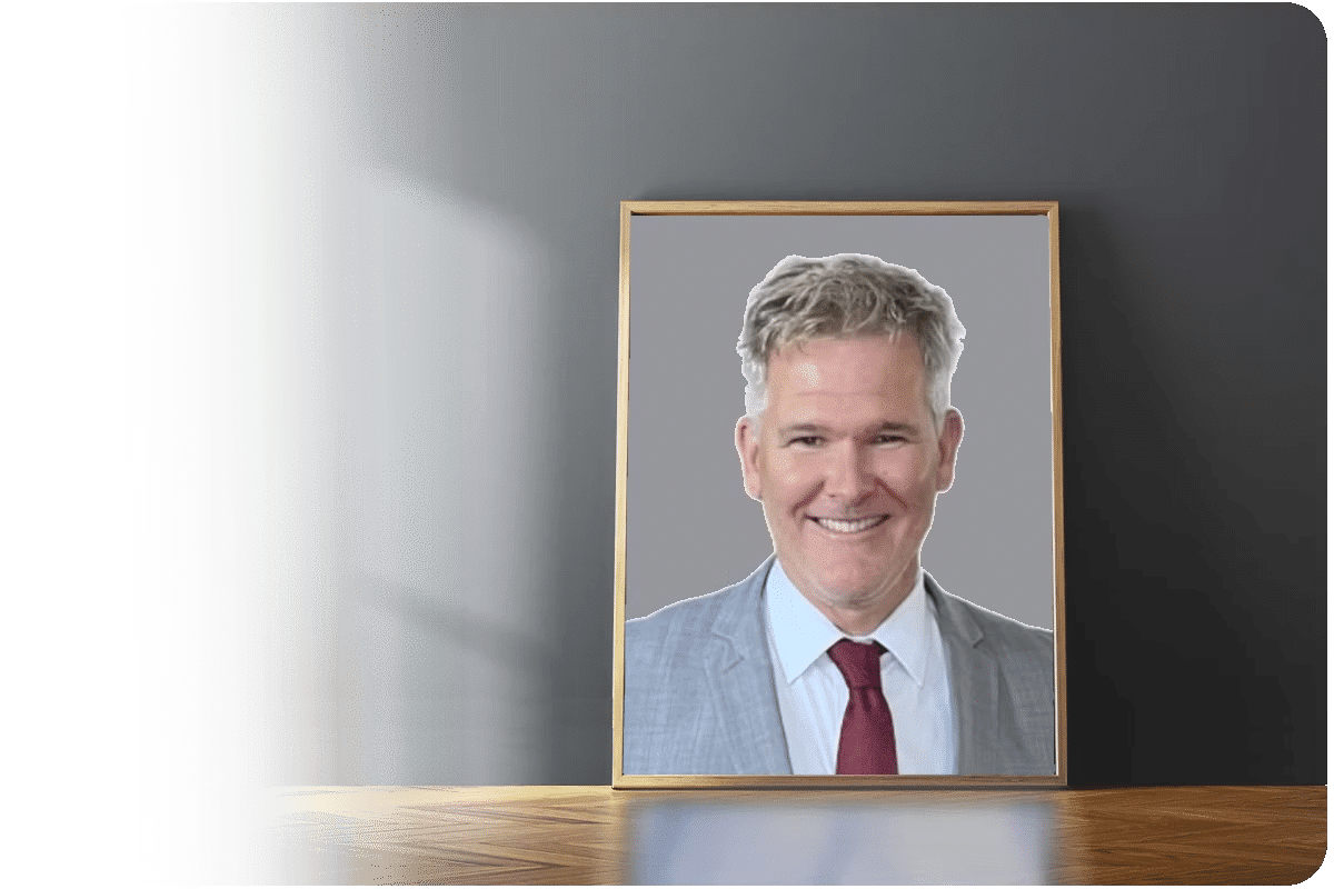 Man pictured in frame against grey wall